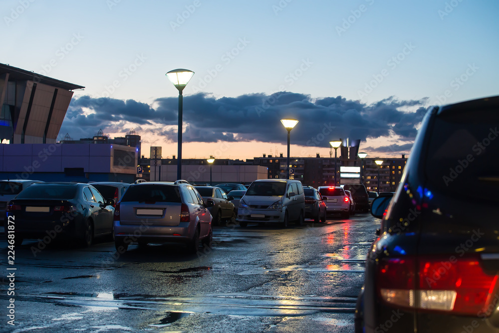 Poster Cars in the city in the parking lot at night