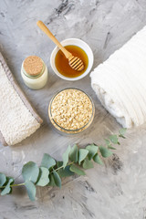 Fototapeta na wymiar Natural Ingredients Homemade Body Oatmeal Sea Salt Scrub with Olive Oil Honey Milk White Towel Beauty Concept Skincare Organic Aroma Spa Therapy