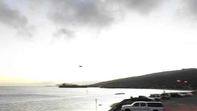 Sunset on the coast of Honolulu in Hawaii. Boats, Jets Skis, and Cars