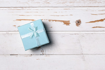 Gift box on wooden background.