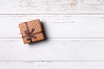 Gift box on wooden background.