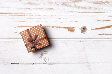 Gift box on wooden background.