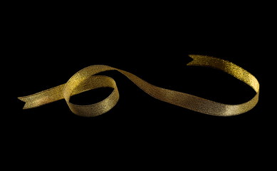 Golden ribbon isolated on black background and texture, with clipping path