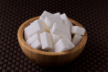 wooden bowl filled with sugar cubes