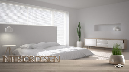 Fototapeta na wymiar Wooden table, desk or shelf with potted grass plant, house keys and 3D letters making the words interior design, over blurred modern bedroom, project concept copy space background