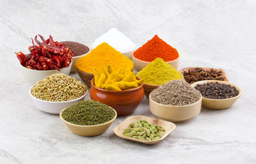Indian Spices Collection Also Called Chili Powder, Turmeric Powder, Coriander, Fenugreek, Cumin, Mustard Seed, Salt, Black Pepper, Cardamom, Cloves, Turmeric Stick, Dry Chili on Vintage Background