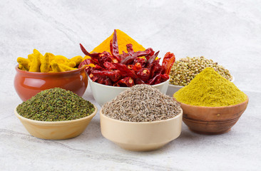 Indian Spices Collection Also Called Turmeric Powder, Coriander Powder, Turmeric Stick, Dry Chili, Fenugreek, Cumin, Coriander Seeds, Mirchi, Haldi, Methi, Dhaniya, Jeera on Vintage Background