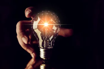 Foto op Plexiglas man hand choose glow light bulb creativity business ideas concept black background © whyframeshot