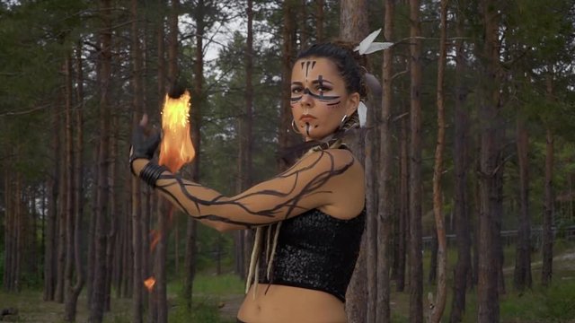 Woman with trible makeup do fire show