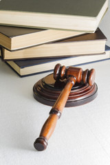 hammer judge on the background of a pile of books, the image on a light background.