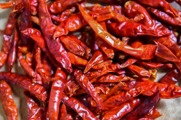Dried chili peppers on a wooden chopping Board