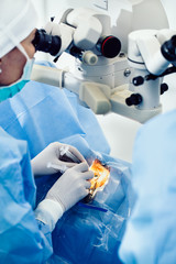 Doctor using microscope during eye surgery process, treatment of cataract and diopter correction....