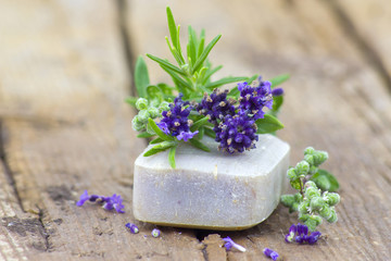 Obraz na płótnie Canvas bar of natural soap and lavender flowers