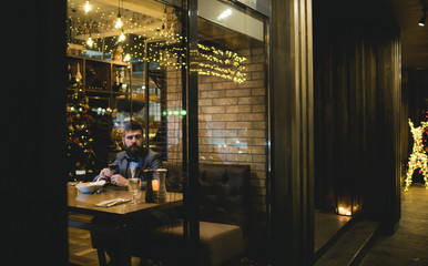 Obraz na płótnie Canvas Bearded man rest in restaurant with wine glass. Bearded man wait in bar and drink wine.