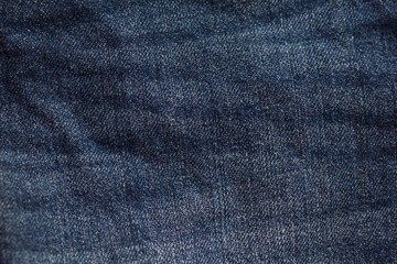 Naklejka premium blue jeans texture wrinkles close up.