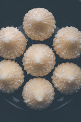 Sweet Modak made using coconut, khoya and sugar. Popular Maharashtrian recipe offered to lord Ganesha in Ganesh Festival. Served in a plate. Selective focus