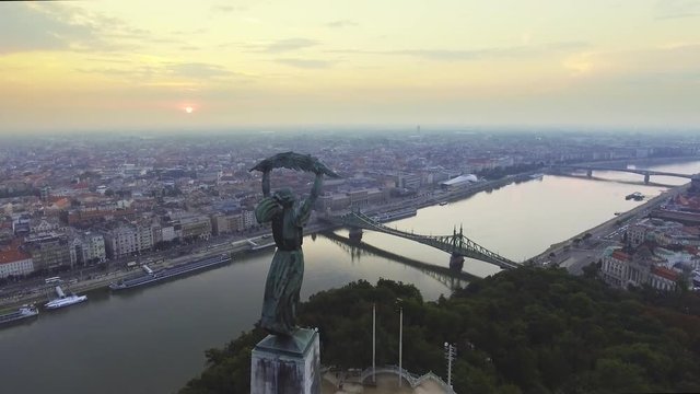 Flying around of Statue of Liberty with the skyline of Budapest at background.