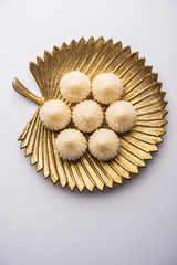 Sweet Modak made using coconut, khoya and sugar. Popular Maharashtrian recipe offered to lord Ganesha in Ganesh Festival. Served in a plate. Selective focus