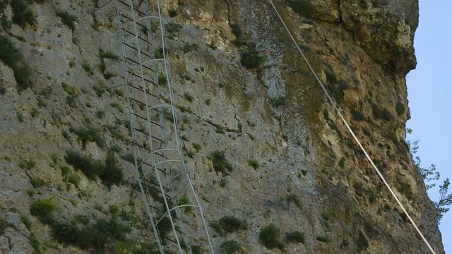Iron ladder on Katskhi Pillar with ancient church on top in Chiatura, Georgia