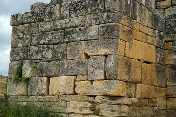 Fragments of the Ruins of the ancient city of H rapolis near the travertine basins of Pamukkale, Turkey. Column. A well-known tourist destination in Turkey.