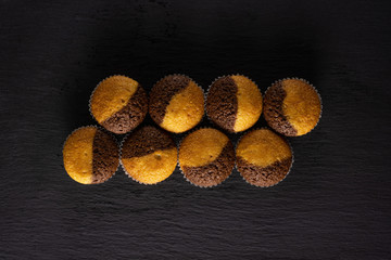 Group of eight whole fresh baked marble muffin flatlay on grey stone