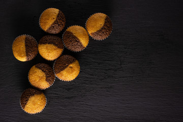 Group of eight whole fresh baked marble muffin flatlay on grey stone
