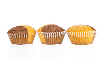 Group of three whole fresh baked marble muffin in row isolated on white background