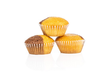 Group of three whole sweet fresh baked marble muffin isolated on white background