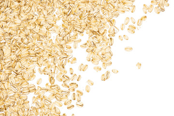 Lot of whole flat raw rolled oats left upper corner isolated on white background