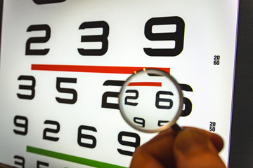 negative concave ophthalmic lens on a blurred background of number eye test