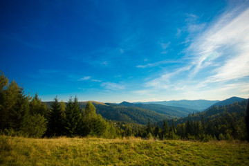 Fototapeta na wymiar Beautiful landscape of summer mountains with blue sky. Autumn mountain village panoramic landscape