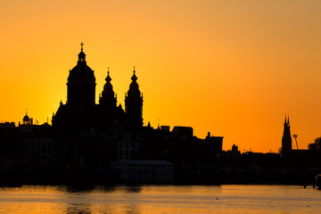 Amsterdam cityscape skyline with Church of Saint Nicholas Sint-Nicolaaskerk during sunset. Picturesque of Amsterdam, Netherlands. Iconic view