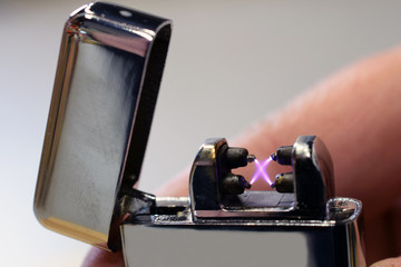 Close up of plasma arc lighter. Windproof, flameless and rechargeable electric lighter. 