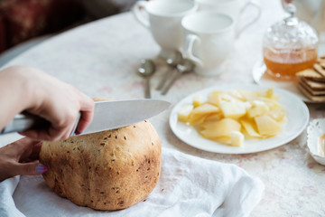 Breakfast in country house. Homemade baked bread, pitcher withmilk on table.