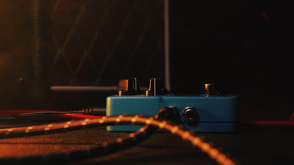 loop pedal for electric guitar. Close up of effect machine on concert scene. Macro view. Neon light