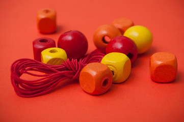 closeup of orange wooden beads on orange background