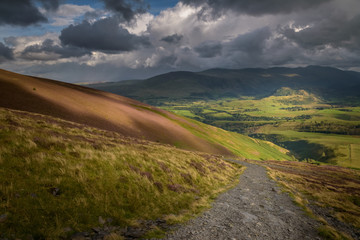 Hiking to the top of skiddaw mountain Lake District England view on Keswick valley with beautiful sunlight