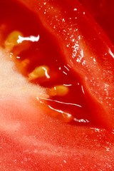 Red tomato in a cut as a background