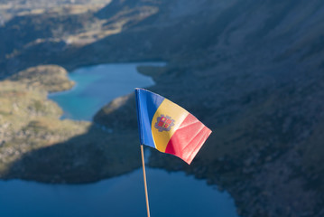 Flag of Andorra Tristaina high mountain lakes in Pyrenees. Andorra