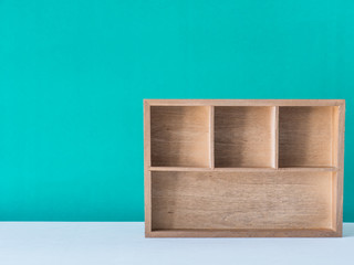 Wooden box on green background,
