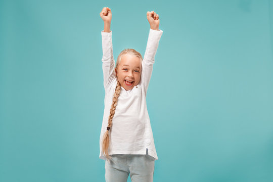 I won. Winning success happy teen girl celebrating being a winner. Dynamic image of caucasian female model on blue studio background. Victory, delight concept. Human facial emotions concept. Trendy