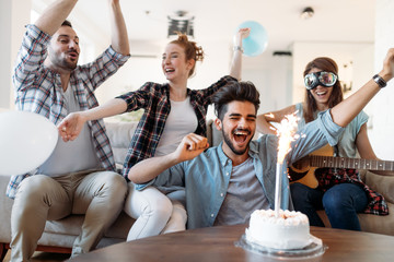 Cheerful young friends having fun on party