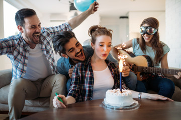 Cheerful young friends having fun on party