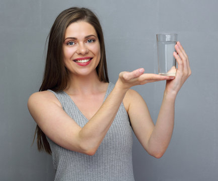 Smiling woman holding water glass on hand.