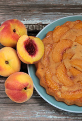 Peach pie on a wooden background
