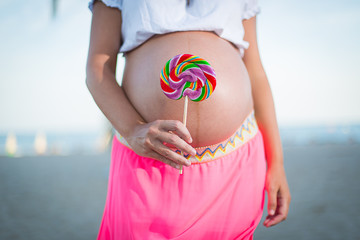 pregnant woman belly with ribbon