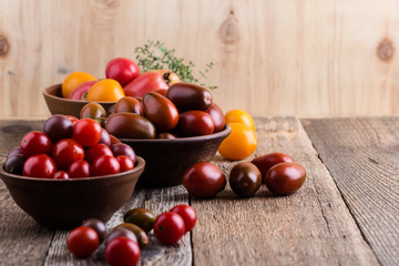 Colorful tomatoes on rural wooden table
