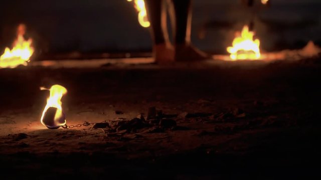 Few burning pois are laying at the ground