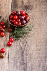 Fototapeta na wymiar Colorful tomatoes on rural wooden table