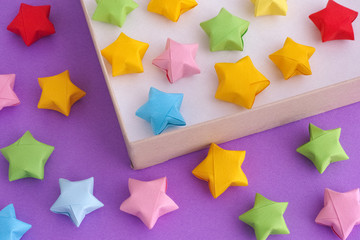 Colorful origami lucky stars in a paper box